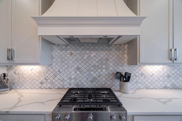 188 Lagoon Dr, Clarks Hill, SC 29821 - kitchen with custom exhaust hood, light stone countertops, backsplash, stove, and white cabinets