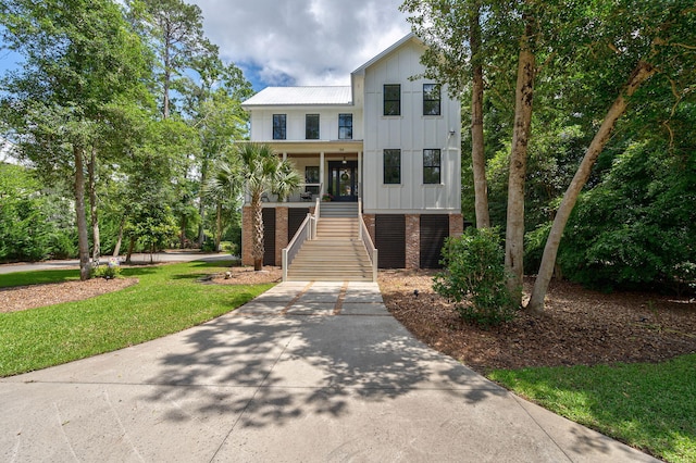 188 Lagoon Dr, Clarks Hill, SC 29821 - view of front of home featuring stairway, board and batten siding, brick siding, and concrete driveway