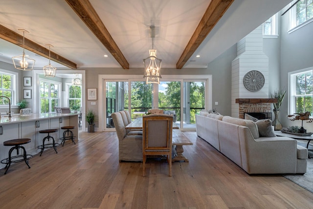 188 Lagoon Dr, Clarks Hill, SC 29821 - dining area featuring a chandelier, light wood finished floors, beam ceiling, and a fireplace
