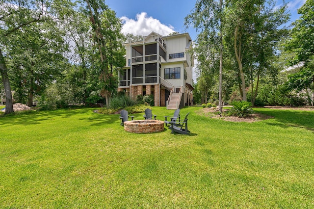 188 Lagoon Dr, Clarks Hill, SC 29821 - back of house featuring a sunroom, a fire pit, stairs, a yard, and brick siding