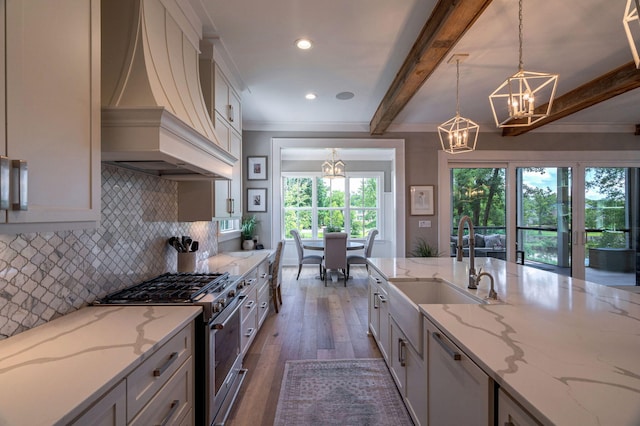 188 Lagoon Dr, Clarks Hill, SC 29821 - kitchen with a chandelier, custom range hood, gas stove, wood finished floors, and tasteful backsplash