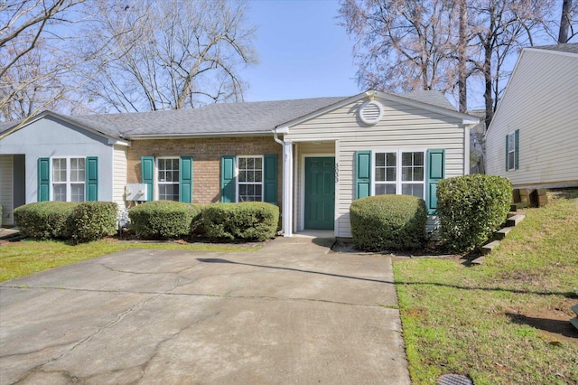 view of front of property featuring brick siding and roof with shingles