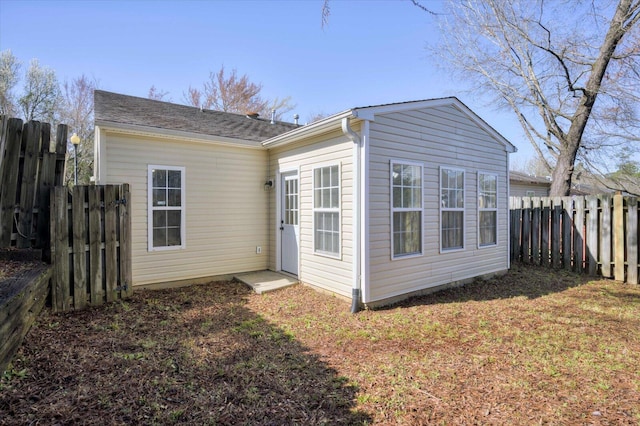 back of house with fence