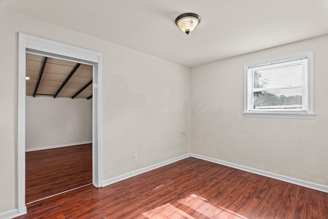 empty room featuring baseboards and wood finished floors