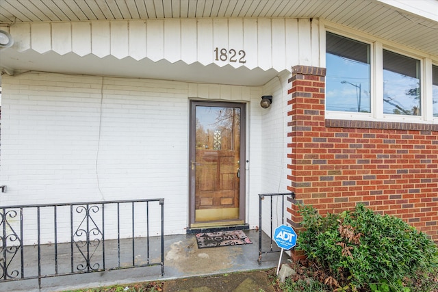 view of exterior entry with brick siding