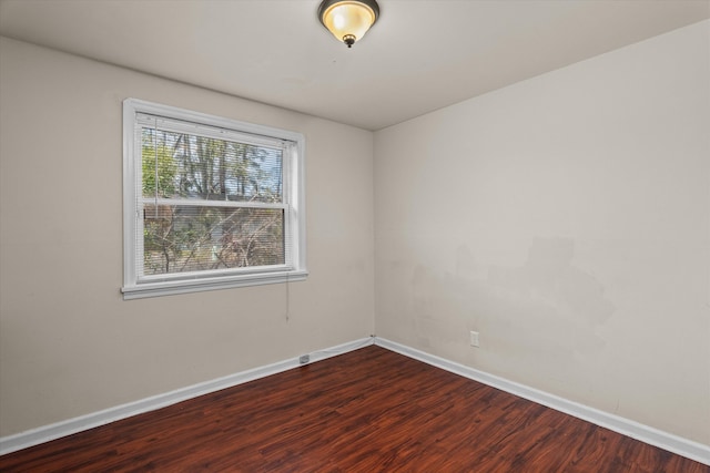 unfurnished room with wood finished floors and baseboards