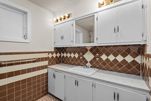 interior space with tile walls, a wainscoted wall, and vanity