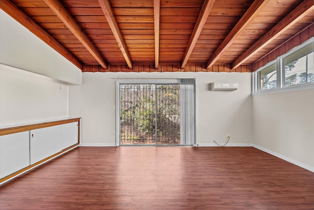 empty room featuring beam ceiling, wood finished floors, a wealth of natural light, and baseboards