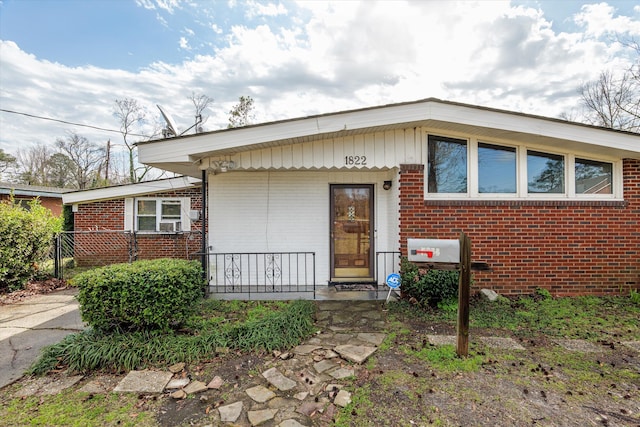 view of front facade with a porch and brick siding