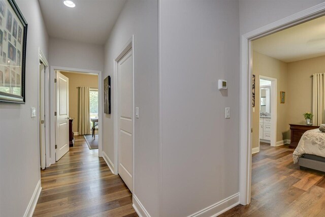 corridor featuring dark wood-type flooring