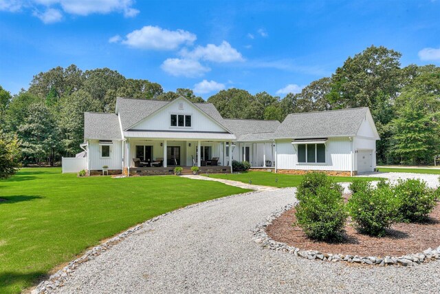 1370 Deerwood Cir, Stapleton, GA 30823 - modern inspired farmhouse featuring an attached garage, roof with shingles, driveway, and covered porch