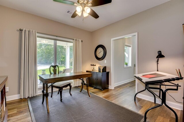 office with ceiling fan and light hardwood / wood-style flooring