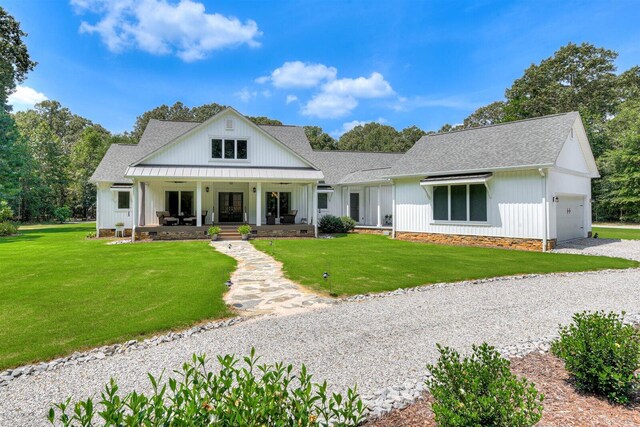 1370 Deerwood Cir, Stapleton, GA 30823 - modern inspired farmhouse with an attached garage, a porch, roof with shingles, and a front yard