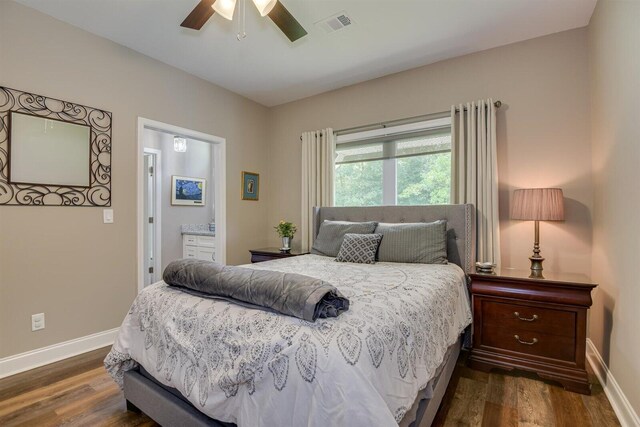 bedroom featuring ensuite bathroom, ceiling fan, and dark wood-type flooring