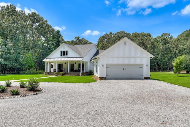 1370 Deerwood Cir, Stapleton, GA 30823 - modern farmhouse style home featuring driveway, a porch, a front yard, and an attached garage