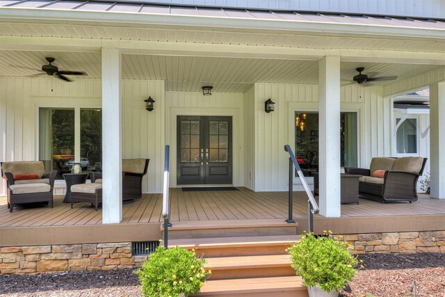 property entrance with a wooden deck, ceiling fan, french doors, and an outdoor living space