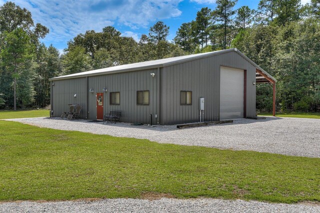 view of outdoor structure with a yard and a garage