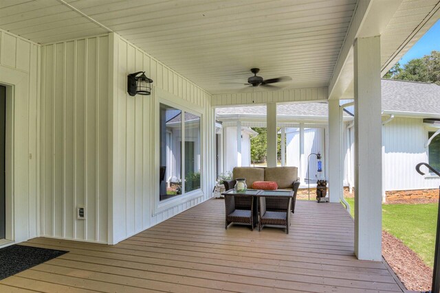 wooden terrace featuring an outdoor living space and ceiling fan