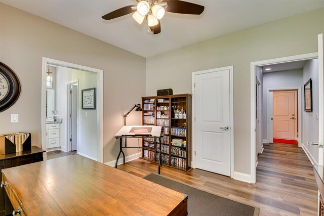 home office with hardwood / wood-style floors and ceiling fan