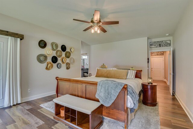 bedroom with ceiling fan and hardwood / wood-style flooring