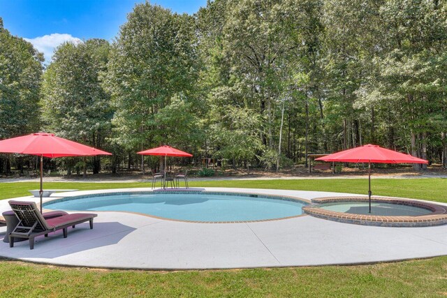 1370 Deerwood Cir, Stapleton, GA 30823 - view of swimming pool featuring a lawn, a patio, and a pool with connected hot tub