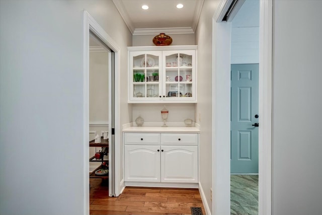 bar featuring crown molding, recessed lighting, light wood-style floors, and visible vents