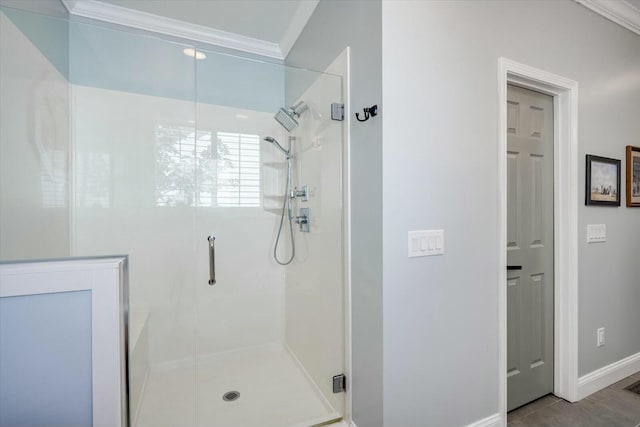 full bathroom featuring a shower stall, baseboards, and ornamental molding