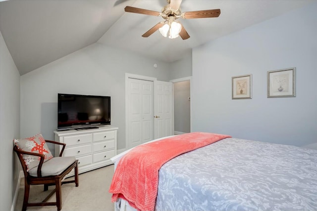 bedroom with a closet, light carpet, lofted ceiling, and ceiling fan