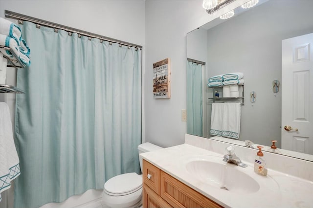 full bath with toilet, vanity, and shower / bath combo