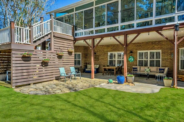 111 Stonebridge Loop, Mccormick, SC 29835 - back of house featuring a patio, brick siding, an outdoor hangout area, a sunroom, and a lawn