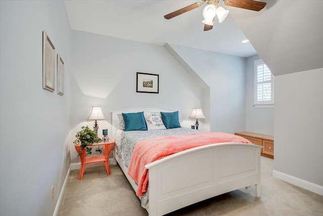 bedroom featuring baseboards, light carpet, and ceiling fan