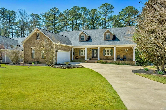 view of front of property featuring a garage, covered porch, concrete driveway, and a front lawn