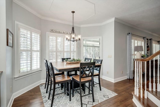 dining space featuring crown molding, dark wood-type flooring, baseboards, stairs, and a notable chandelier