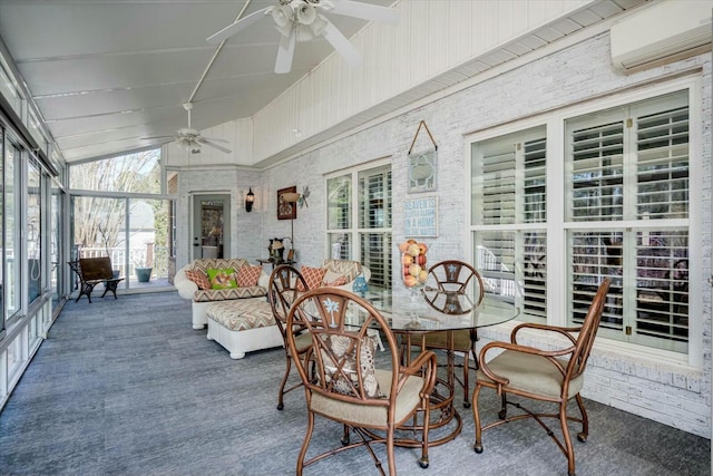 sunroom / solarium with lofted ceiling, a ceiling fan, and a wall mounted AC