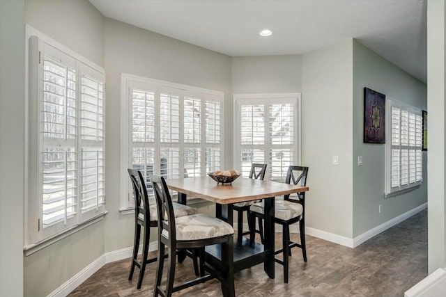 dining space with recessed lighting, baseboards, and dark wood finished floors