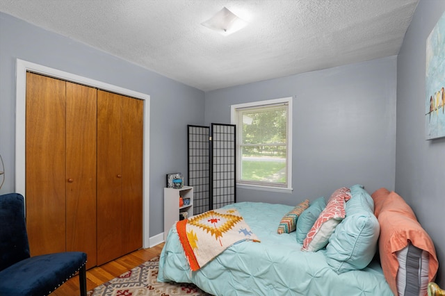818 Hillside Dr, North Augusta, SC 29841 - bedroom featuring light wood-type flooring, a textured ceiling, and a closet
