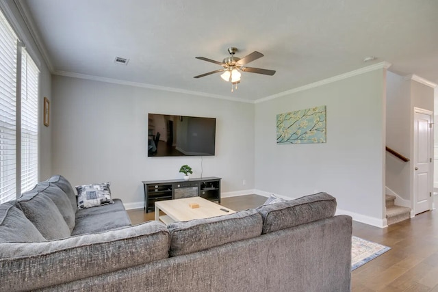 3120 Wayne Dr, Evans, GA 30809 - living area featuring a ceiling fan, wood finished floors, baseboards, stairs, and ornamental molding
