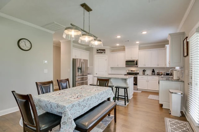 3120 Wayne Dr, Evans, GA 30809 - dining space with ornamental molding, wood finished floors, recessed lighting, and baseboards