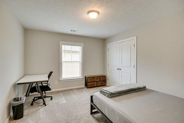 3120 Wayne Dr, Evans, GA 30809 - bedroom with carpet, baseboards, a closet, an office area, and a textured ceiling