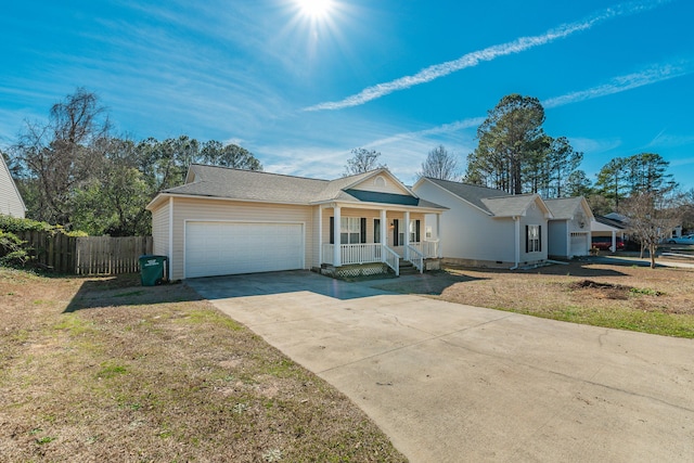 ranch-style home featuring concrete driveway, a porch, an attached garage, and fence