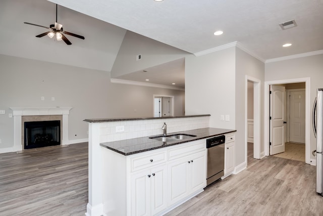 750 Herrington Dr, Grovetown, GA 30813 - kitchen featuring dark stone counters, appliances with stainless steel finishes, a sink, light wood-type flooring, and open floor plan