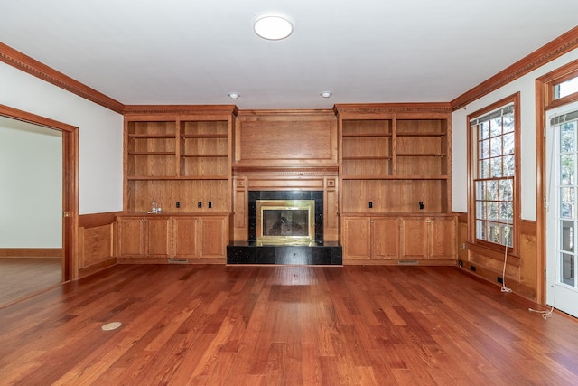 unfurnished living room with dark wood-type flooring, a fireplace, and crown molding