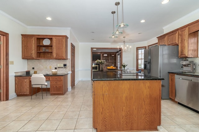 kitchen featuring decorative light fixtures, decorative backsplash, ornamental molding, a center island, and stainless steel appliances