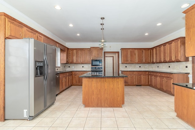 kitchen featuring a kitchen island, pendant lighting, dark stone countertops, ornamental molding, and black appliances