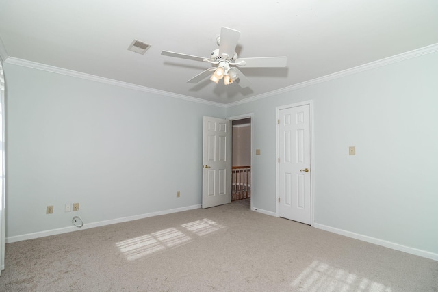 unfurnished room with crown molding and light carpet