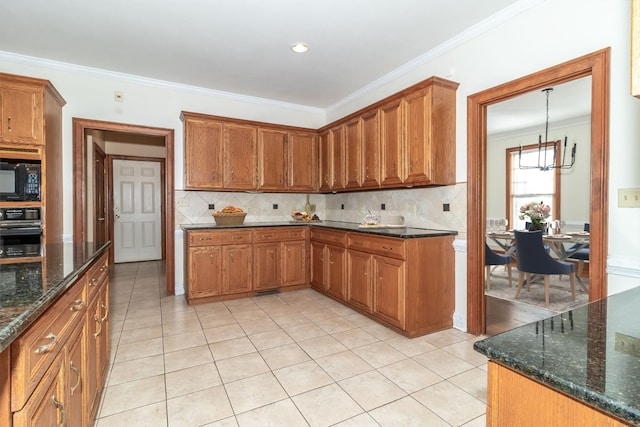 kitchen with ornamental molding, dark stone countertops, decorative backsplash, and black appliances