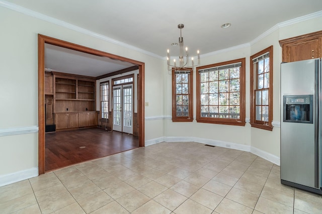 unfurnished dining area with crown molding, a chandelier, french doors, and light tile patterned floors