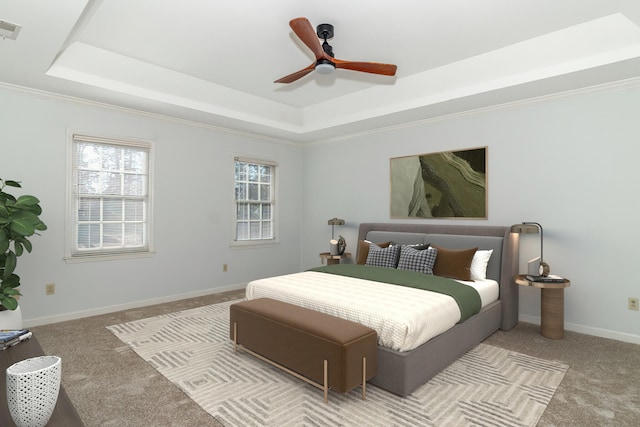 bedroom featuring ceiling fan, light colored carpet, and a tray ceiling