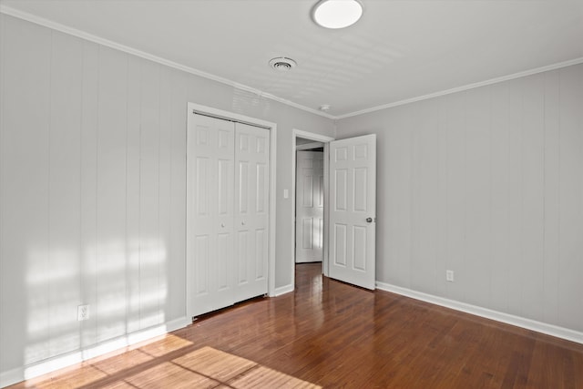 2131 Reedale Ave, Augusta, GA 30906 - unfurnished bedroom featuring wood finished floors, a closet, ornamental molding, and baseboards