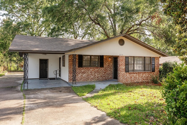 2131 Reedale Ave, Augusta, GA 30906 - view of front facade with brick siding, driveway, and a carport